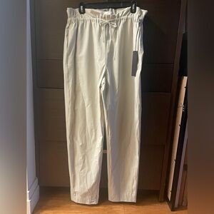 Carbon paper bag, drawstring, cream slacks. Comfy, stretchy fabric.